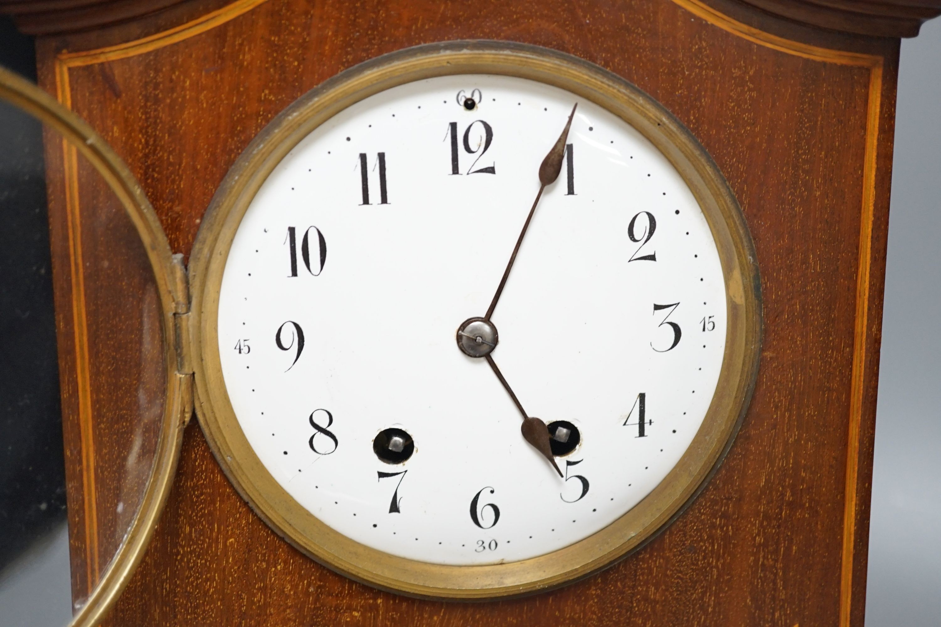 An Edwardian inlaid mahogany mantel clock with French gong-striking movement, 39cm.